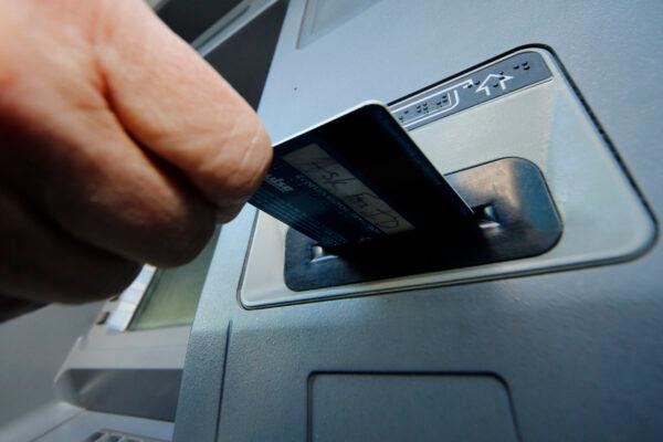 A person inserts a debit card into an ATM in Pittsburgh, PA. on Jan. 5, 2013. (Gene J. Puskar/AP Photo)