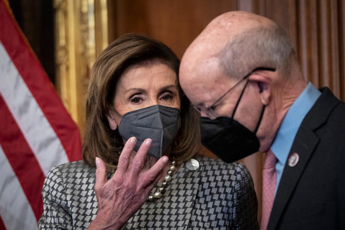 (L-R) House Speaker Nancy Pelosi (D-Calif.) talks with Rep. Peter DeFazio (D-Ore.) during an event about the COMPETES Act at the U.S. Capitol in Washington, DC., on Feb. 4, 2022. (Drew Angerer/Getty Images)