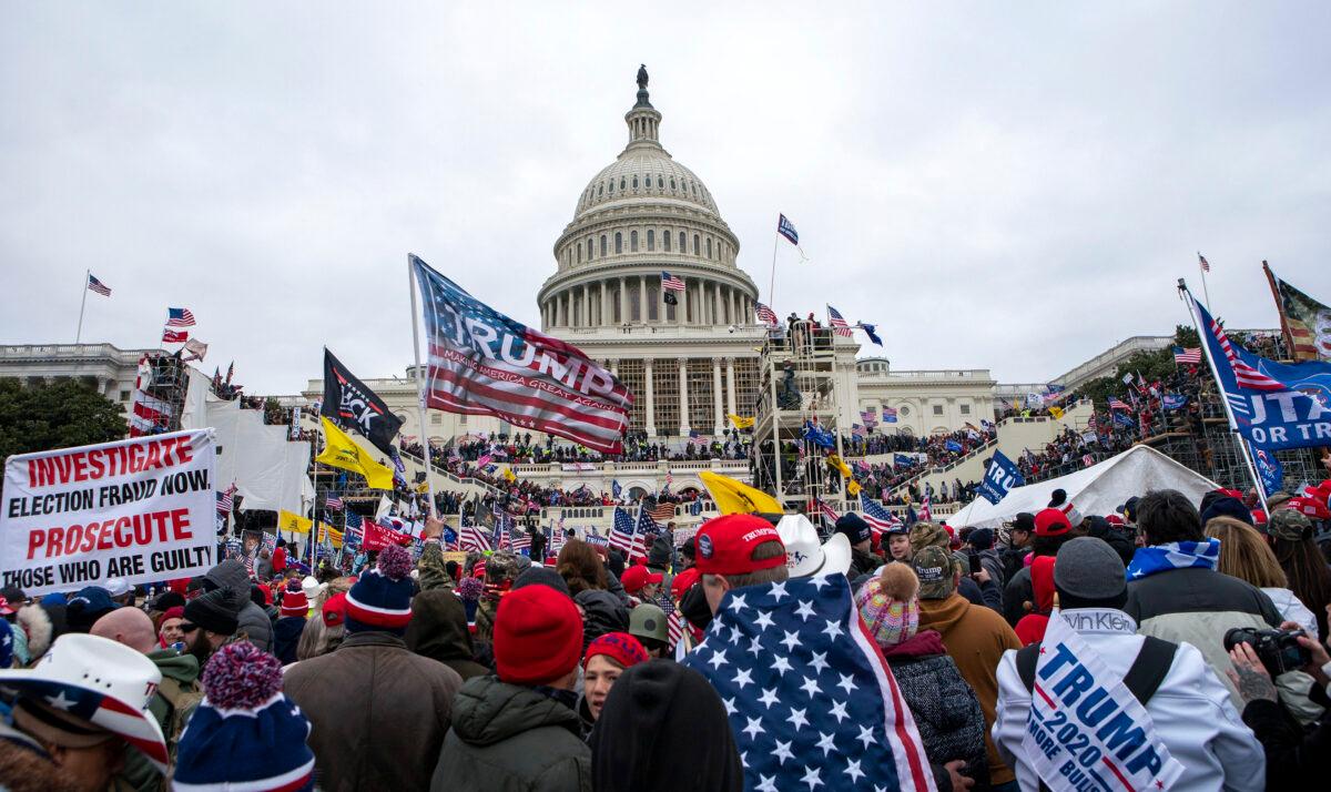 Protesters loyal to President Donald Trump rally at the U.S. Capitol in Washington on Jan. 6, 2021. A judge ruled on April 8, 2022, that the conspiracy case against 10 Oath Keepers will be split into two trials, one in July and the other in September. (Jose Luis Magana/AP Photo)