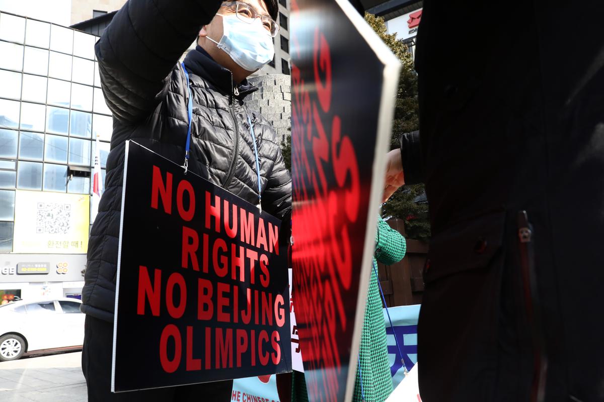 Protesters hold placards reading, "No Human Rights, No Beijing Olympics," during an anti-Olympics rally in front of the Chinese Embassy in Seoul, South Korea, on Feb. 09, 2022. (Chung Sung-Jun/Getty Images)