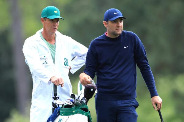 Scottie Scheffler (R) and caddie Ted Scott look on from the 15th hole during the second round of The Masters at Augusta National Golf Club, in Augusta, Ga., on April 8, 2022. (David Cannon/Getty Images)