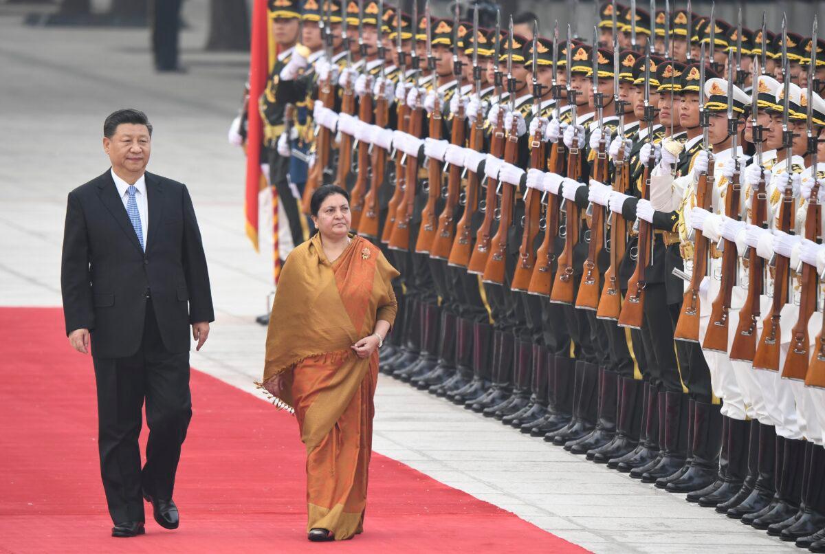 Chinese leader Xi Jinping and Nepalese President Bidhya Devi Bhandari review honor guards during a welcome ceremony at the Great Hall of the People in Beijing, China, on April 29, 2019. (Madoka Ikegami/Pool/Getty Images)