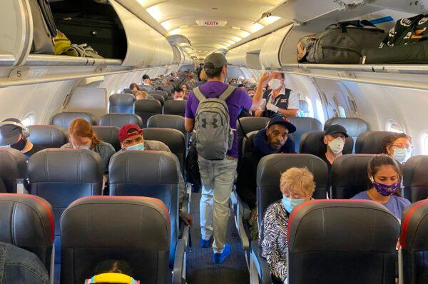 Passengers board an American Airlines flight in New York City, on May 3, 2020. (Eleonore Sens/AFP via Getty Images)