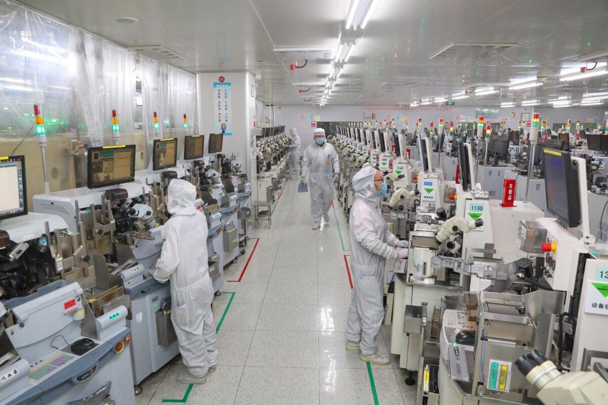 Staff work in TongFu Microelectronics (TFME) in Nantong in east China's Jiangsu Province on Nov. 14, 2020. (Feature China/Future Publishing via Getty Images)