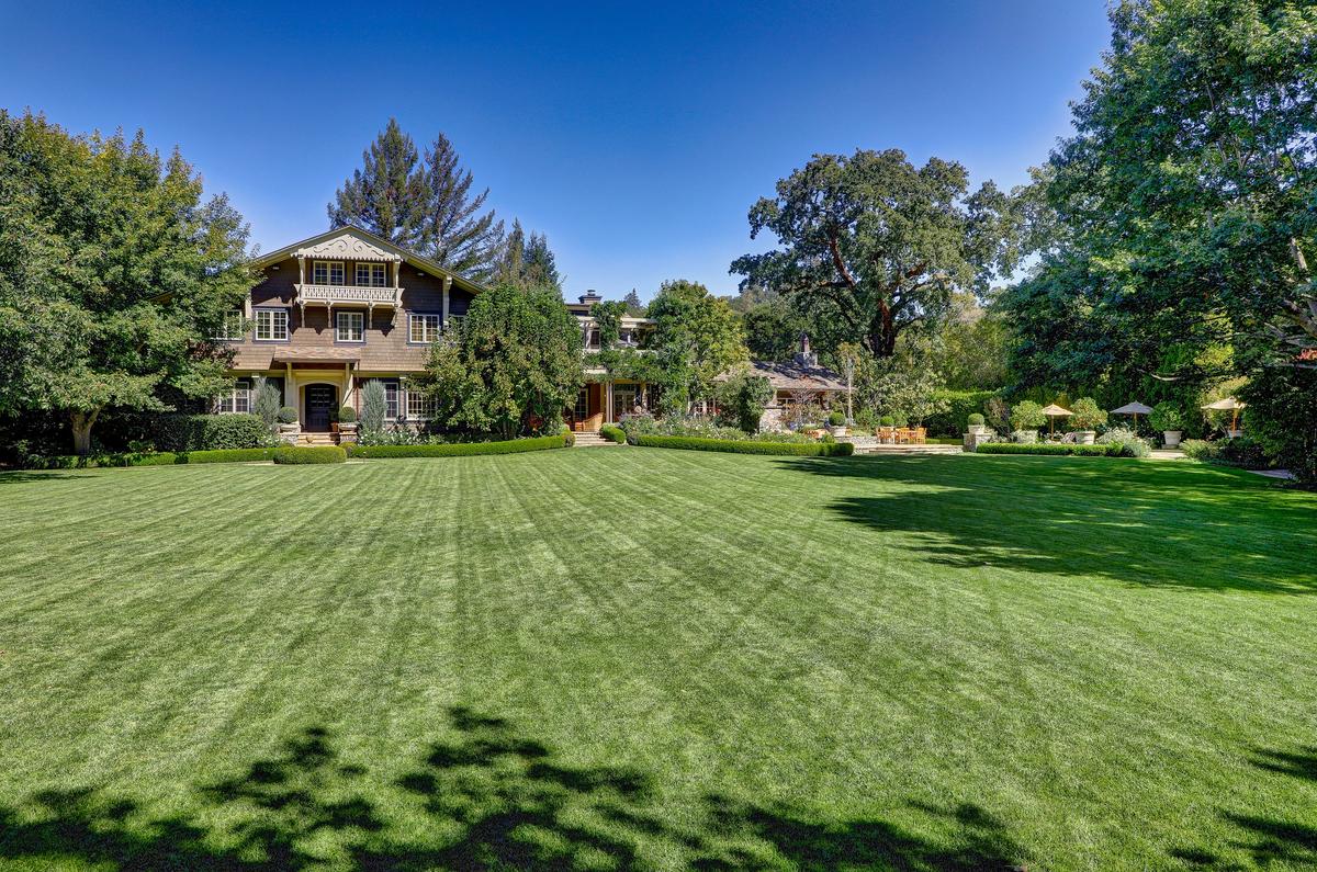  Surrounded by extensive manicured lawns, lush gardens, and mature trees, the property boasts a 10,000-gallon well for landscape irrigation, fully fenced grounds, state-of-the-art security, and a covered dog run. (Courtesy of Jason Wells Photography and Golden Gate Creative/Tracy McLaughlin)
