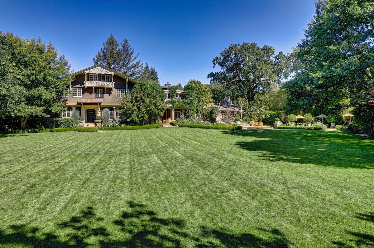 Surrounded by extensive manicured lawns, lush gardens, and mature trees, the property boasts a 10,000-gallon well for landscape irrigation, fully fenced grounds, state-of-the-art security, and a covered dog run. (Courtesy of Jason Wells Photography and Golden Gate Creative/Tracy McLaughlin)