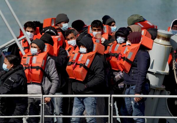 A group of people thought to be illegal immigrants are brought in to Dover, Kent, England, on April 15, 2022. (Gareth Fuller/PA Media)