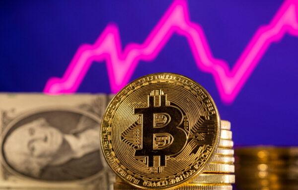 A representation of cryptocurrency Bitcoin is seen in front of a stock graph and U.S. dollar in this illustration, on Jan. 24, 2022. (Reuters/Dado Ruvic/File Photo)