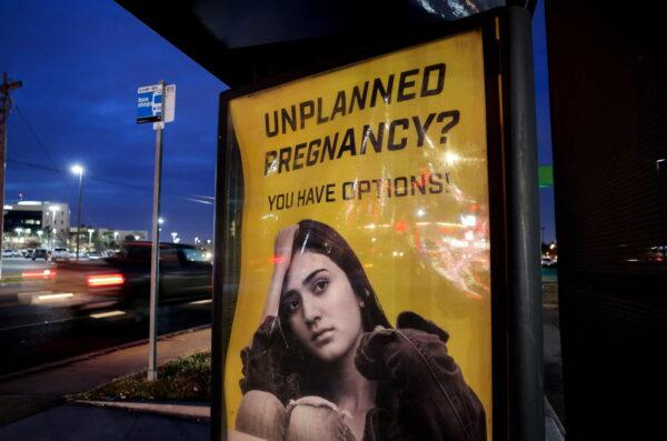 A billboard advertising adoption services targets pregnant women at a bus stop in Oklahoma City, Oklahoma, on Dec. 7, 2021. (Evelyn Hockstein/Reuters)