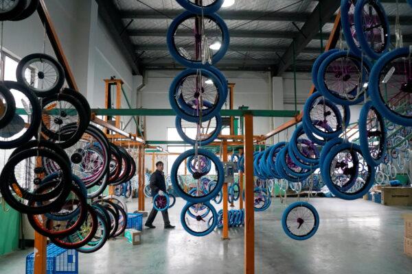 An employee works on the production line of Kent bicycles at Shanghai General Sports Co., Ltd., in Kunshan, Jiangsu Province, China, on Feb. 22, 2019. (Aly Song/Reuters)