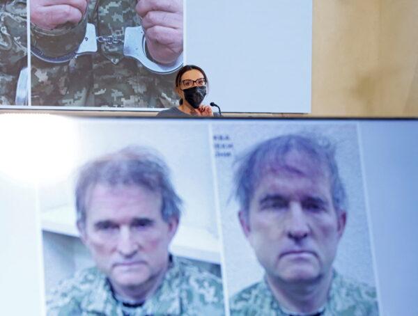 Oksana Marchenko, wife of pro-Russian Ukrainian politician Viktor Medvedchuk who was detained in Ukraine, attends a news conference, while pictures of her husband are displayed on screens, in Moscow, Russia April 15, 2022. REUTERS/Maxim Shemetov