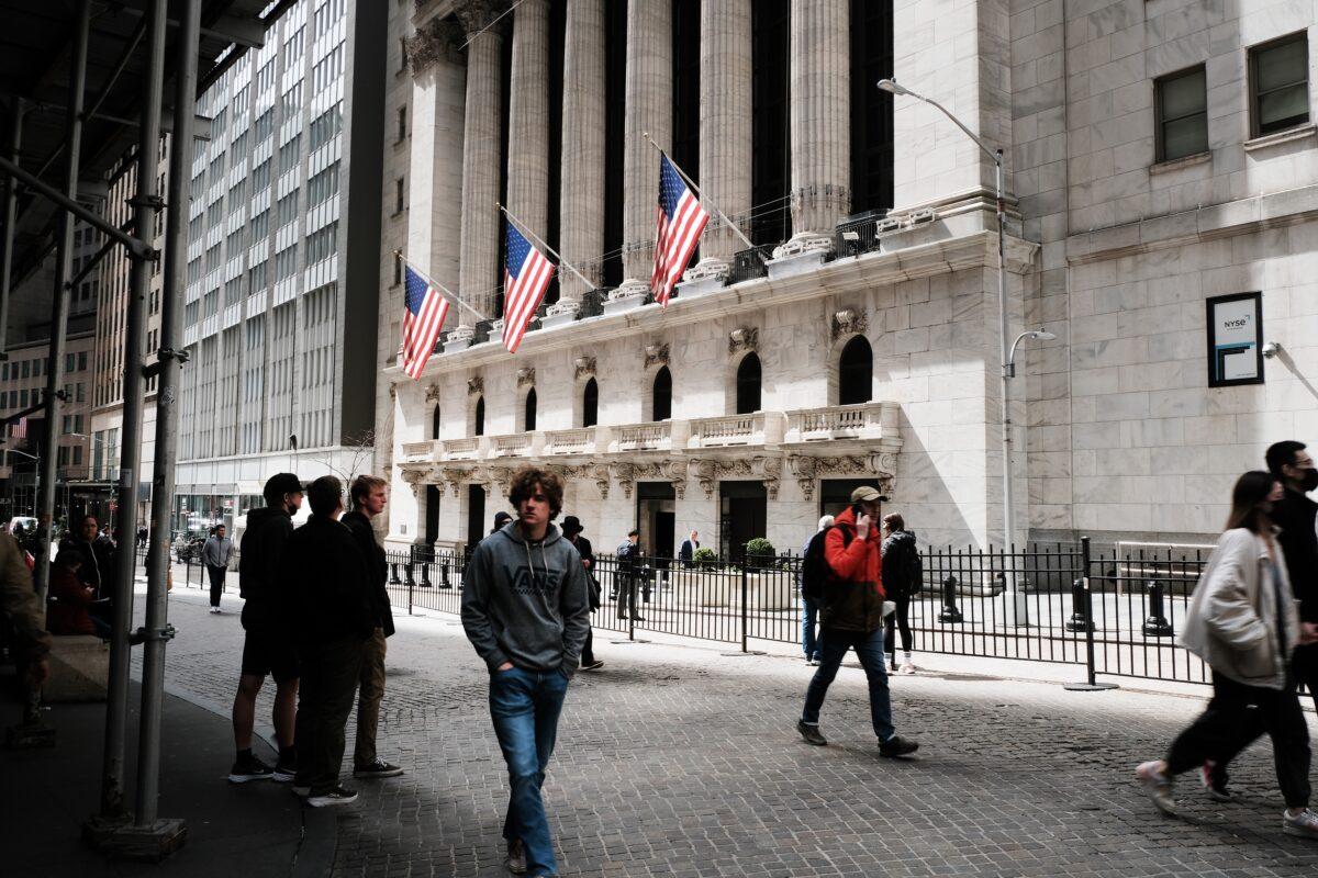 People walk by the New York Stock Exchange in New York City on April 4, 2022. (Spencer Platt/Getty Images)