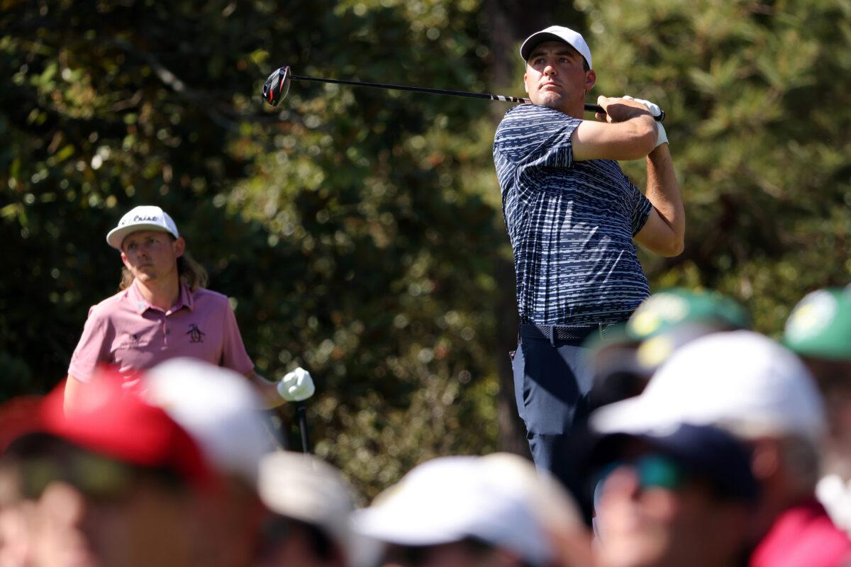 Scottie Scheffler plays his shot from the fifth tee as Cameron Smith of Australia looks on during the final round of the Masters at Augusta National Golf Club, in Augusta, Georgia, on April 10, 2022. (Jamie Squire/Getty Images)