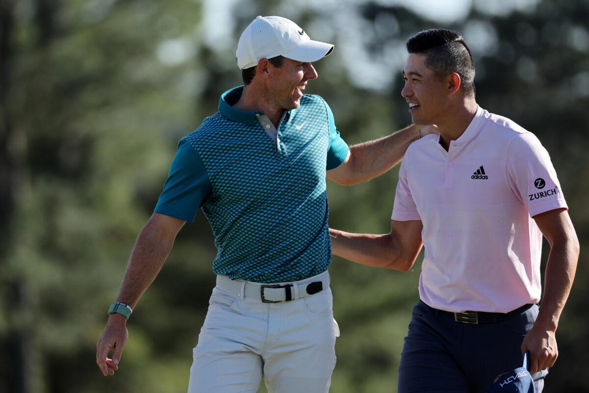 Rory McIlroy of Northern Ireland (L) and Collin Morikawa celebrate on the 18th green after finishing their round during the final round of the Masters at Augusta National Golf Club , in Augusta, Georgia, on April 10, 2022. (Gregory Shamus/Getty Images)