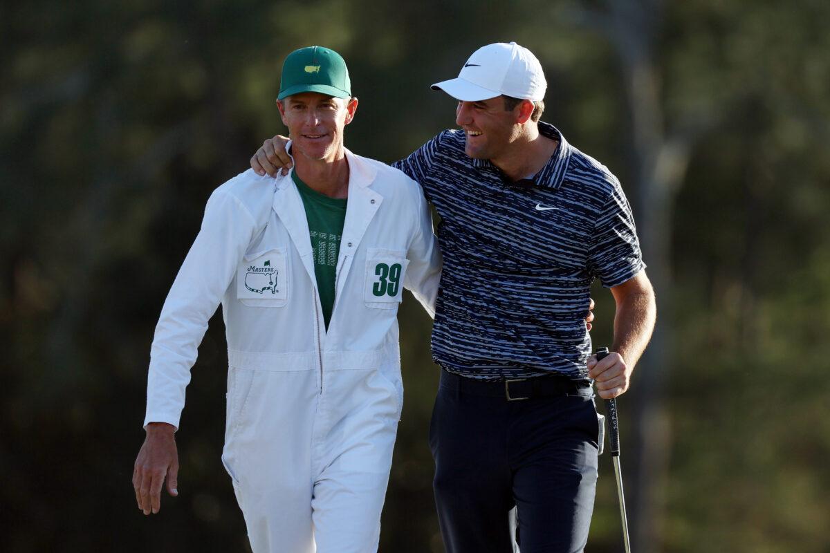 Scottie Scheffler and caddie Ted Scott celebrate on the 18th green after winning the Masters at Augusta National Golf Club , in Augusta, Georgia, on April 10, 2022. (Gregory Shamus/Getty Images)