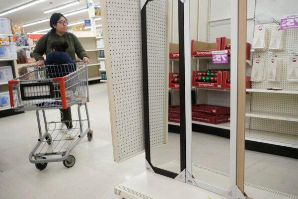 People shop the half-empty shelves of the Kmart in Avenel, N.J., on April 4, 2022. (Seth Wenig/AP Photo)