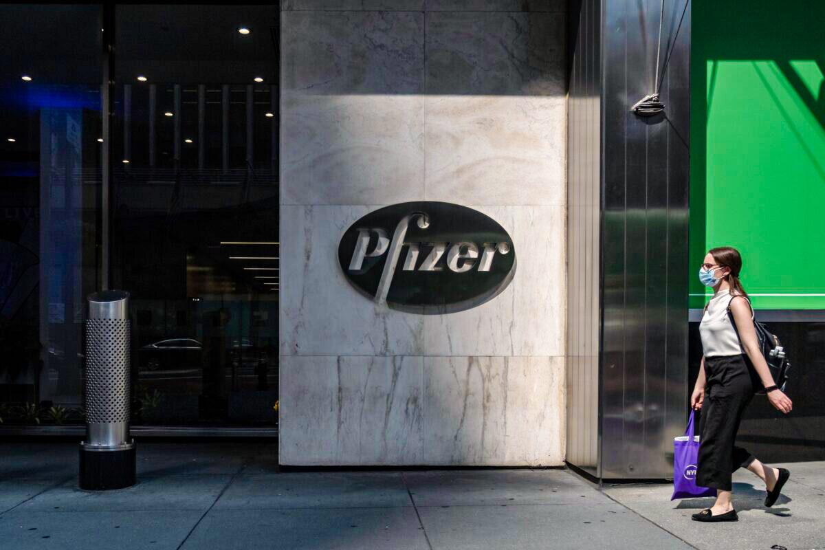 A pedestrian walks by Pfizer's New York City headquarters in a file photograph. (Jeenah Moon/Getty Images)