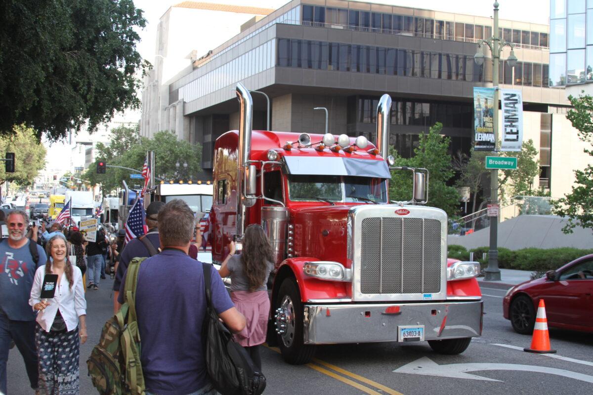 Trucks from the People's Convoy parked outside the “Defeat the Mandates” rally in Los Angeles on April 10, 2022. (Brad Jones/The Epoch Times)