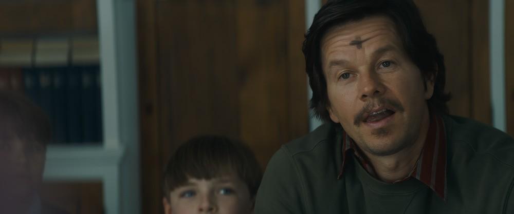Stu Long (Mark Wahlberg), sitting in on one of Carmen's classes on Ash Wednesday, in "Father Stu." (Columbia Pictures/Sony Pictures Releasing)