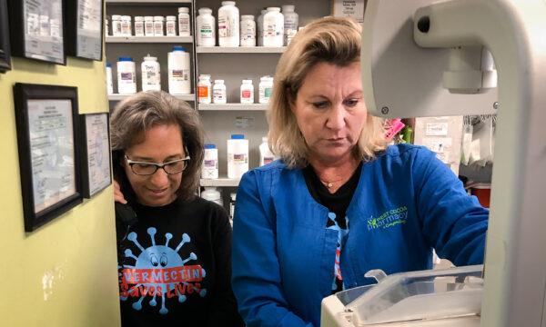 Donna Lowery (L) helps pharmacist Dawn Butterfield, owner of West Cocoa Pharmacy and Compounding in Cocoa, Fla., who's using automated pill counter to fill a prescription. (Courtesy of Donna Lowery)