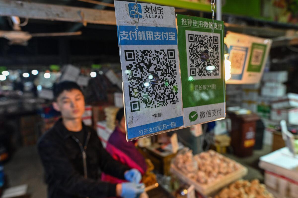 Alipay (L) and Wechat (R) QR payment codes are displayed at a market in Shanghai on Oct. 27, 2020. (Hector Retamal/AFP via Getty Images)