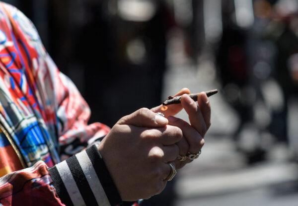 An activist smokes marijuana during the annual NYC Cannabis Parade & Rally in support of the legalization of marijuana for recreational and medical use in New York City on May 1, 2021. (Angela Weiss/AFP via Getty Images)