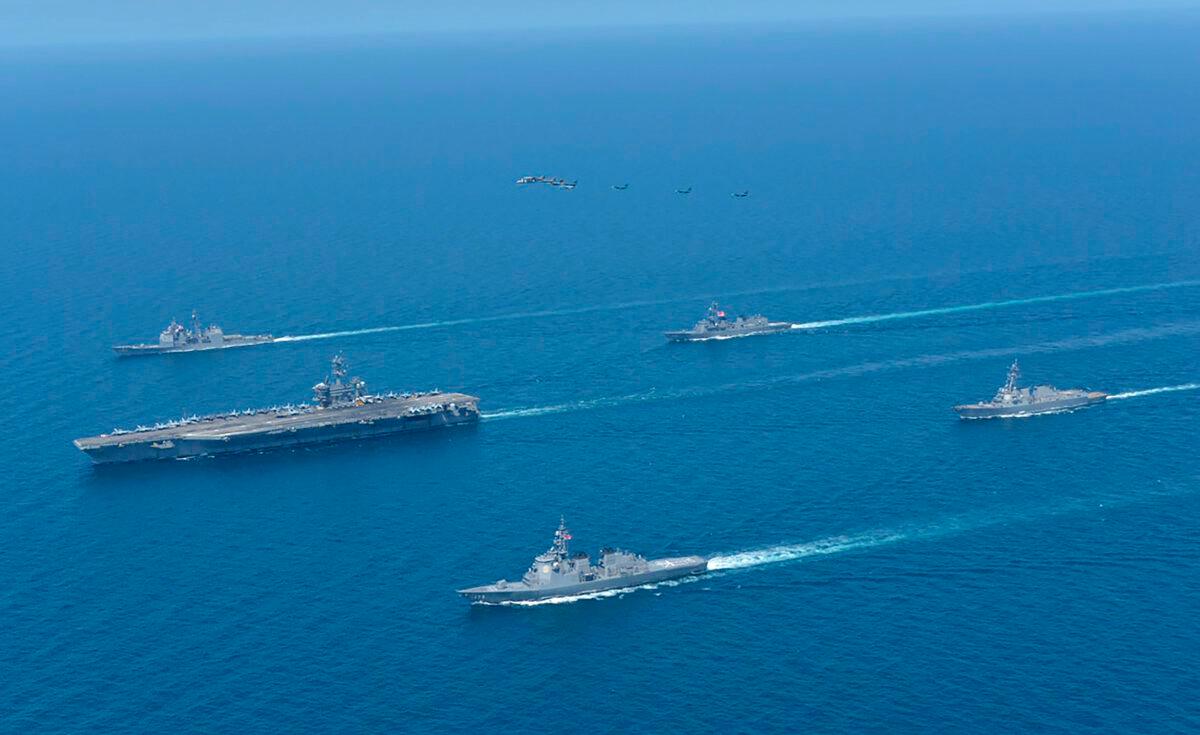 USS Abraham Lincoln (L), and JS Kongo (front), sail in formation during a U.S.-Japan bilateral exercise at the Sea of Japan on April 12, 2022. (Japan Maritime Self-Defense Force via AP)