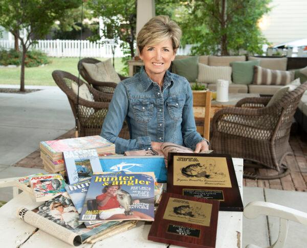 Jenn Duff shows off awards and magazine stories about her pro-angling days. (Ivan Martinez)