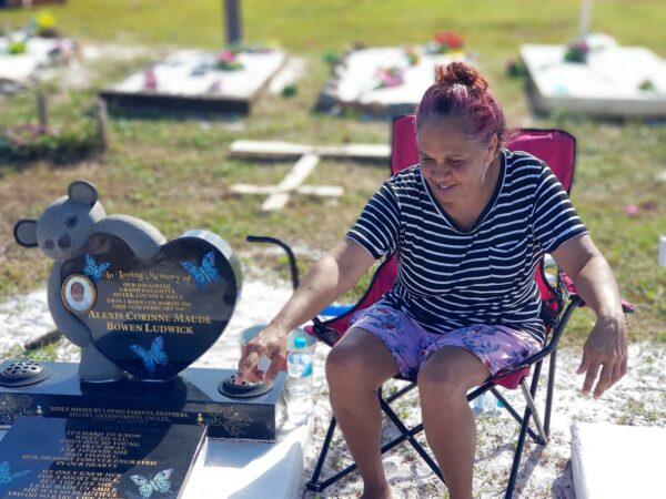 Joanne Bowen at the grave of her daughter at Hope Vale cemetery. (Courtesy of Caden Pearson)