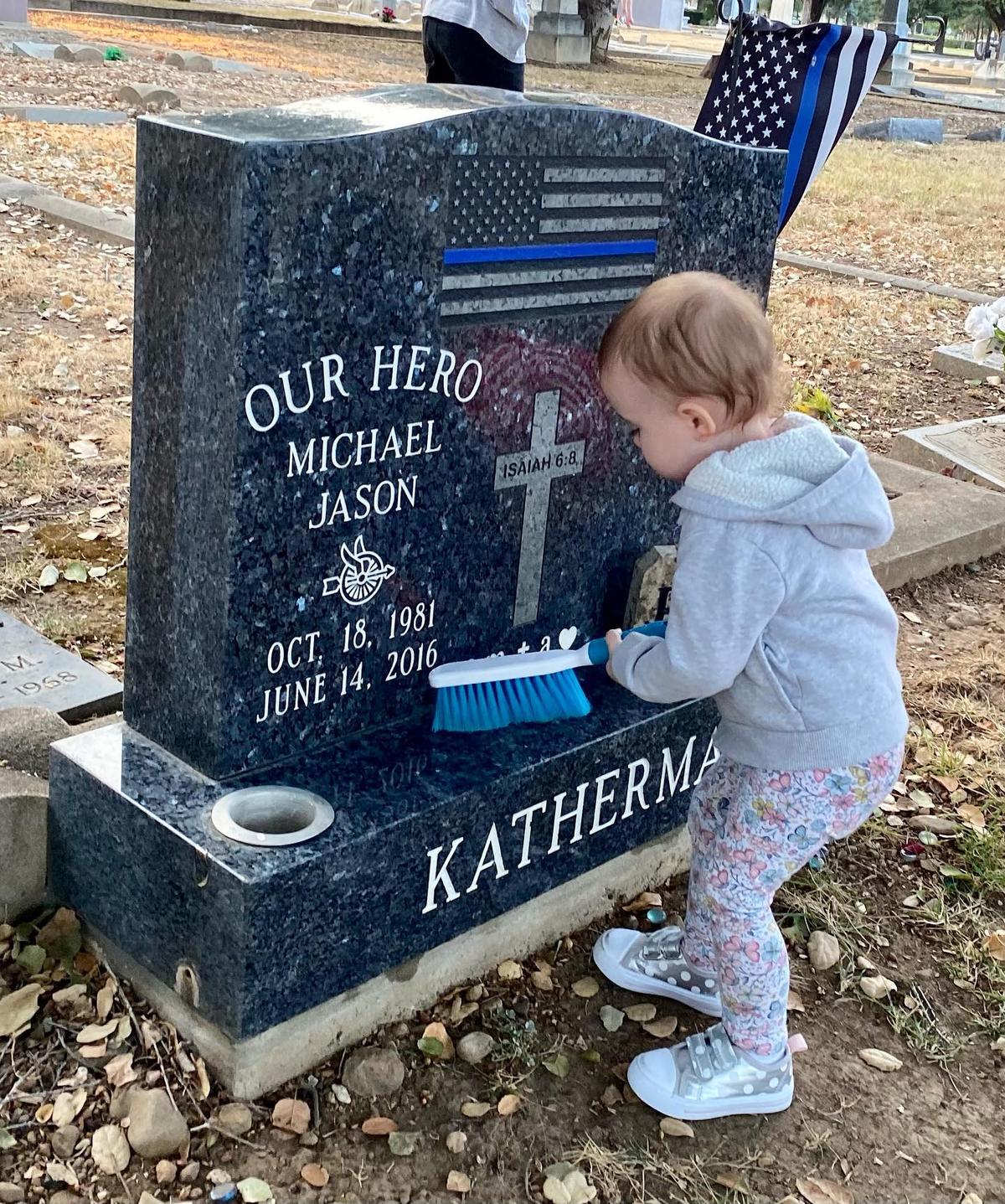 David and April's baby daughter helping clean Mike's grave. (Courtesy of <a href="https://www.instagram.com/beautyforourashesblog/">April Katherman-Redgrave</a>)
