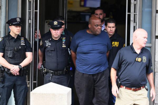 Suspect Frank James is led by police from Ninth Precinct after being arrested for his connection to the mass shooting at the 36th St subway station in New York on April 13, 2022. (Michael M. Santiago/Getty Images)