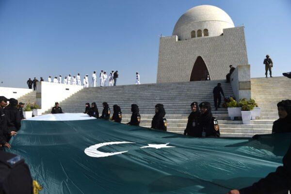 Police women hold a national flag at the mausoleum of Pakistan's founding father, Muhammad Ali Jinnah, during events to mark his birth anniversary in Karachi, Pakistan, on Dec. 25, 2019. (Rizwan Tabassum/AFP via Getty Images)