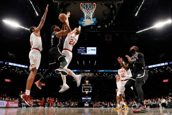 Bruce Brown #1 of the Brooklyn Nets goes to the basket as Evan Mobley #4 and Lauri Markkanen #24 of the Cleveland Cavaliers defend during the Eastern Conference 2022 Play-In Tournament at Barclays Center, in the Brooklyn borough of New York, on April 12, 2022. (Sarah Stier/Getty Images)