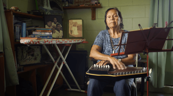 The late Dorothy Rosendale, a church elder at St John's Lutheran Church, plays the autoharp and sings "How Great Thou Art." (Courtesy of Caden Pearson)