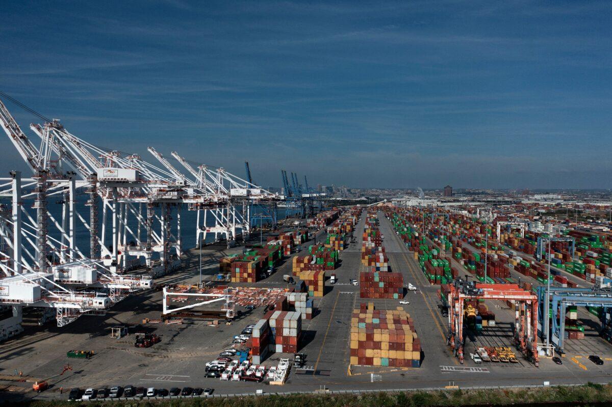 Cargo containers are readied for transport at the Port of Baltimore in Baltimore, Maryland, on Oct. 14, 2021. Closed factories, clogged ports, and a lack of truck drivers have been raising concerns that they could exacerbate the global supply chain and disrupt the global economic recovery. (Brendan Smialowski/AFP via Getty Images)