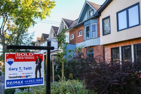 A sold sign is displayed in front of a house in the Riverdale area of Toronto on Sept. 29, 2021. (The Canadian Press/Evan Buhler)