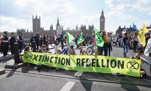 Demonstrators take part in an Extinction Rebellion protest on Westminster Bridge in London on April 15, 2022. (Stefan Rousseau/PA Media)