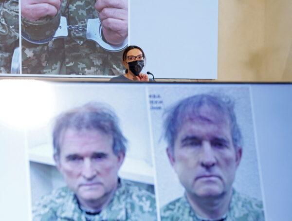 Oksana Marchenko, wife of pro-Russian Ukrainian politician Viktor Medvedchuk who was detained in Ukraine, attends a news conference, while pictures of her husband are displayed on screens, in Moscow, Russia, on April 15, 2022. (Maxim Shemetov/Reuters)