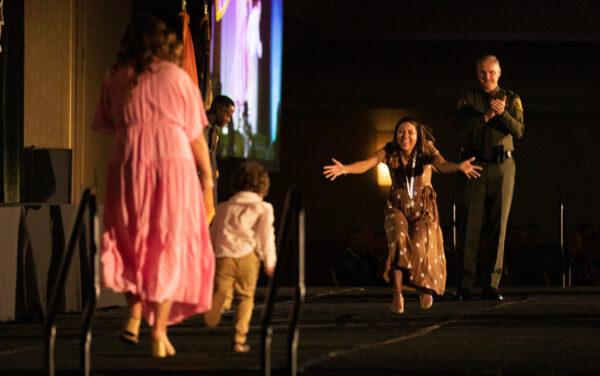 Recipient of the Sheriff's Award Julia Bonin is surprised to see formerly kidnapped child Noah Clare, whom she assisted in rescuing, at the Orange County Sheriff's Department awards ceremony celebration in Anaheim, Calif., on April 14, 2022. (John Fredricks/The Epoch Times)