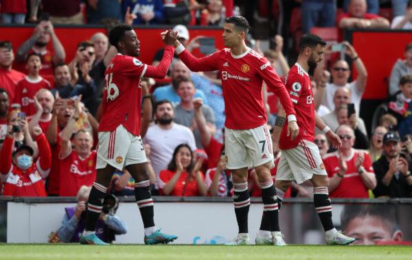 Cristiano Ronaldo of Manchester United celebrates with teammate Anthony Elanga after scoring their side's first goal during the Premier League match between Manchester United and Norwich City at Old Trafford, in Manchester, England, on April 16, 2022. (Jan Kruger/Getty Images)