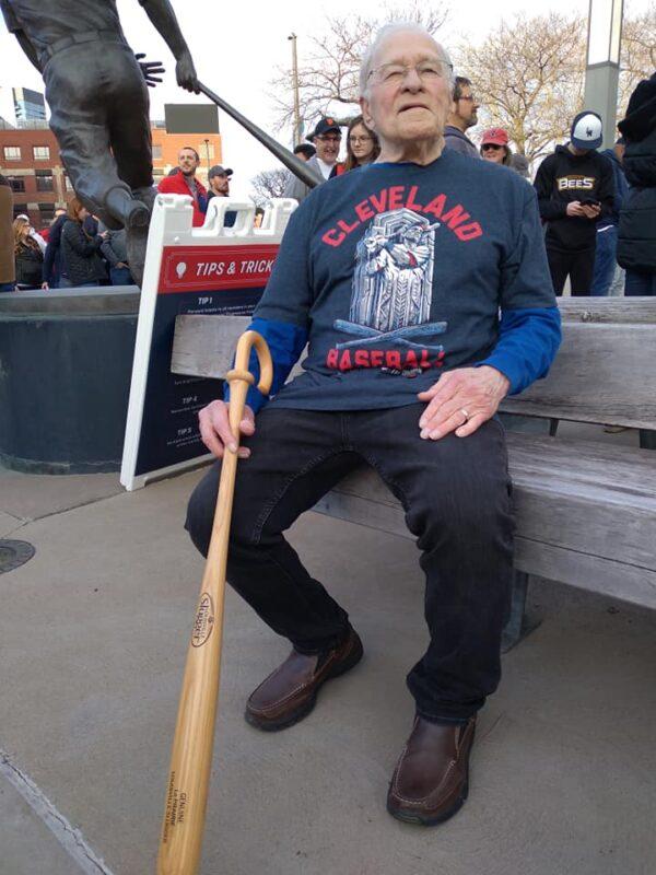 Going to bat for Guardians: Allen LaPrairie, 81, waits for his wife to join him at the Cleveland Guardians home opener at Progressive Field on April 15, 2022. LaPrairie, who lives in a Cleveland suburb of Geauga County, said he agreed with his son that the Guardians was the best choice for a new team name. LaPrairie has been attending Cleveland baseball games in Cleveland for 62 years. (Michael Sakal/The Epoch Times)