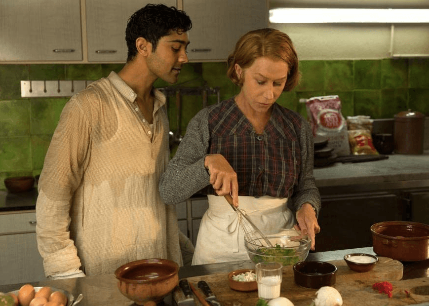 Hassan (Manish Dayal) gets some cooking tips from Madam Mallory (Helen Mirren) in "The Hundred Foot Journey." (DreamWorks Pictures)