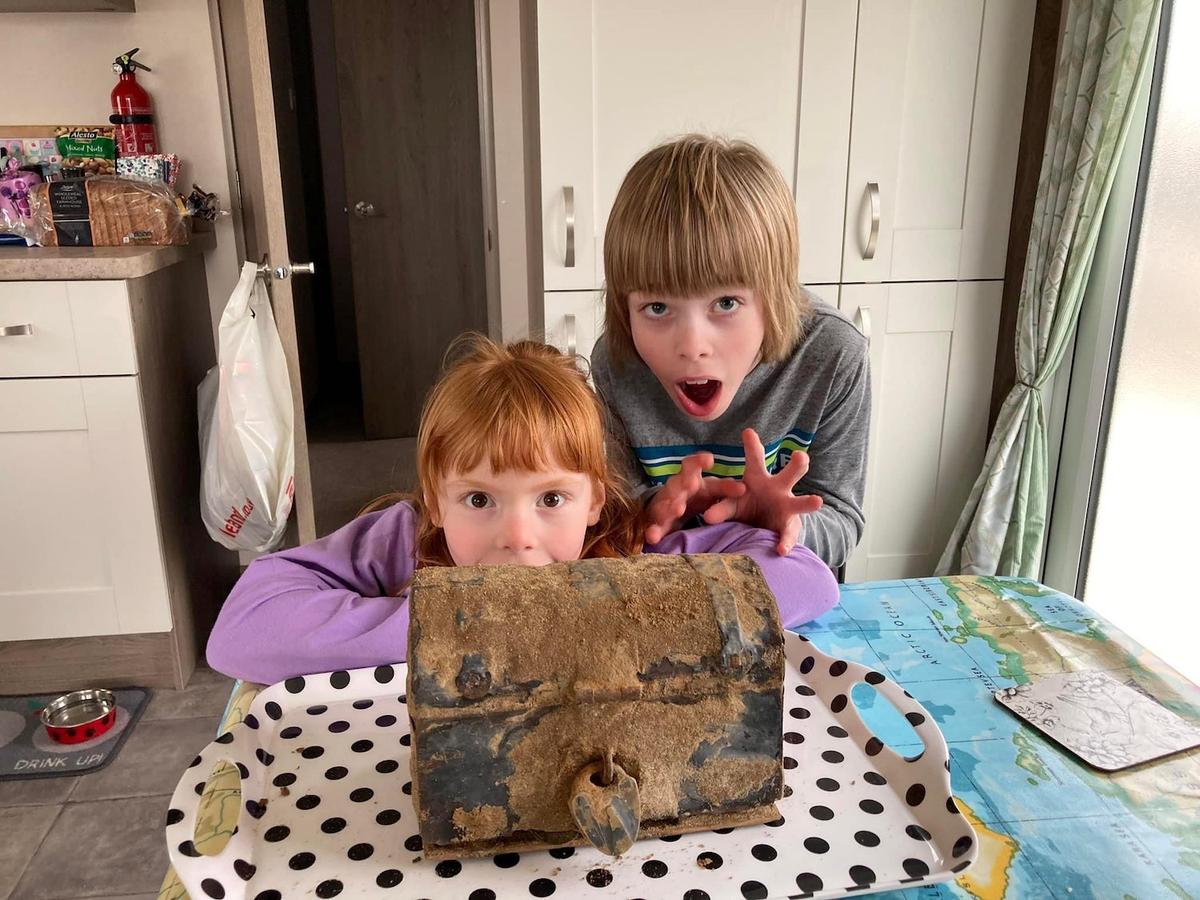 Darcey and Harrison with the treasure chest. (SWNS)