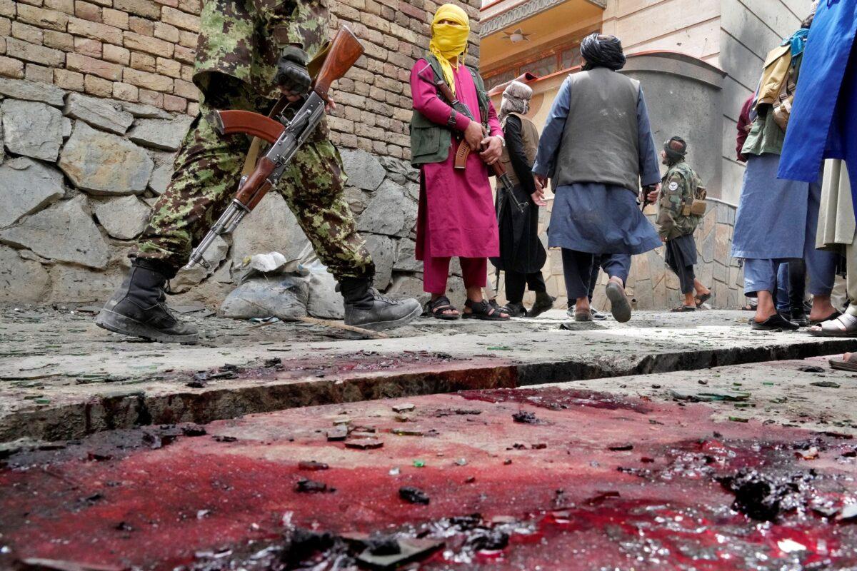 Taliban fighters stand guard at the site of an explosion in front of a school, in Kabul, Afghanistan, on April 19, 2022<span class="_3_yxGICNhkrUIOBvfC0QEW">. </span>(Ebrahim Noroozi/AP Photo)