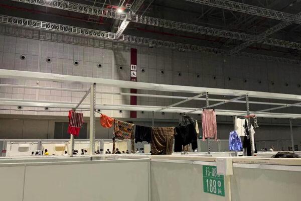 Clothes are hung on a partitions at the National Exhibition and Convention Center in Shanghai on April 15, 2022. ( Beibei via AP)