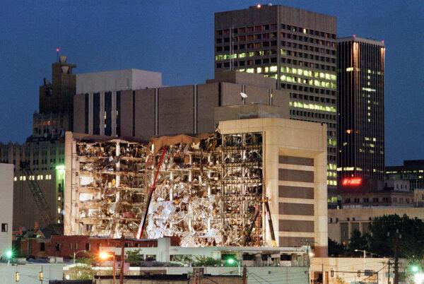 Floodlights illuminate the Albert P. Murrah Federal Building in Oklahoma City on April 20, 1995, as rescuers continue searching for bodies in the aftermath of the April 19 explosion caused by a fuel and fertilizer truck bomb that was detonated early April 19 in front of the building. (PDAEMMRICH/AFP via Getty Images)