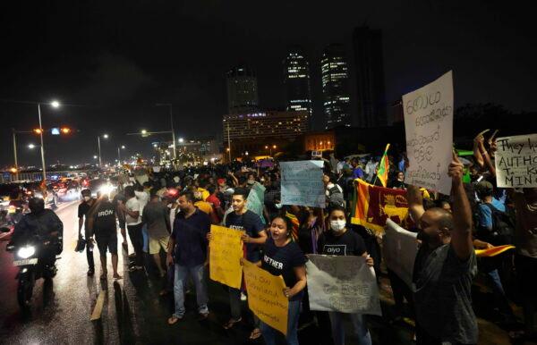 Sri Lankans during a protest outside the president's office in Colombo, Sri Lanka, on April 11, 2022. (Eranga Jayawardena/AP Photo)