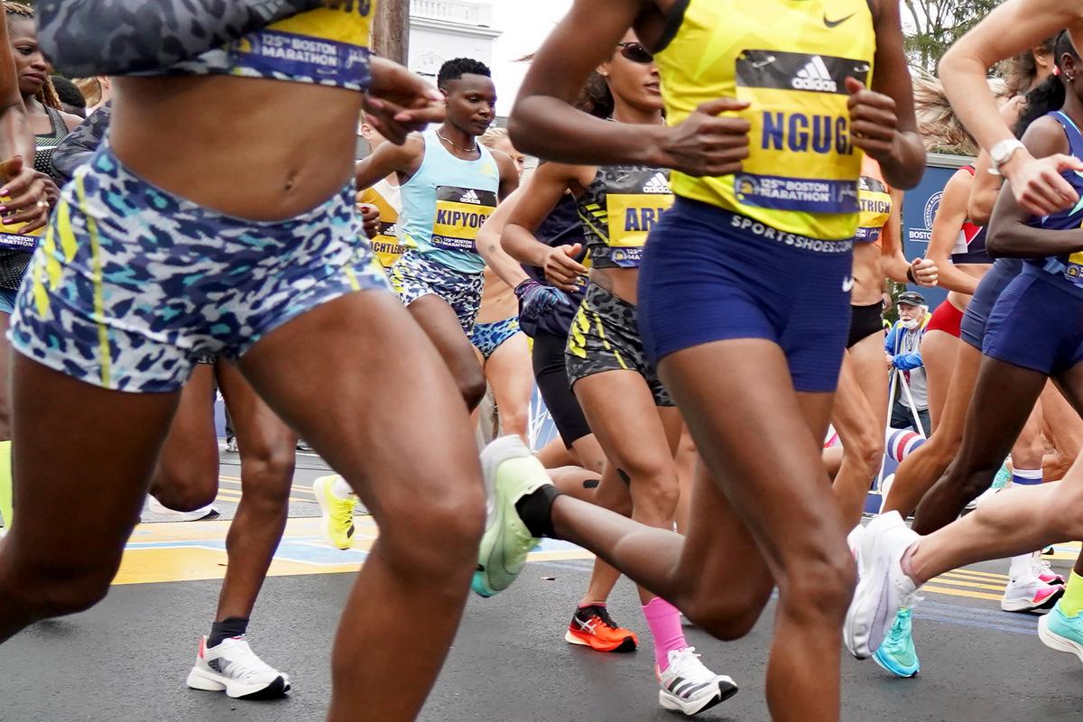 Elite women's runner Diana Kipyogei of Kenya (C) breaks from the start in the center of the pack in the 125th Boston Marathon in Hopkinton, Mass. on Oct. 11, 2021. (Mary Schwalm/AP Photo)