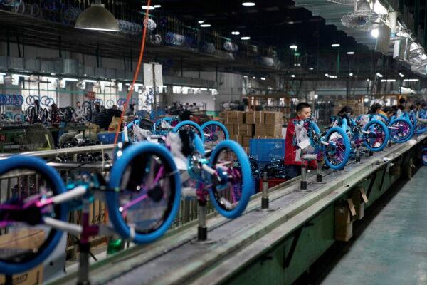 Employees work on the production line of Kent bicycles at Shanghai General Sports Co., in Kunshan, Jiangsu Province, China, on Feb. 22, 2019. (Aly Song/File Photo/Reuters)