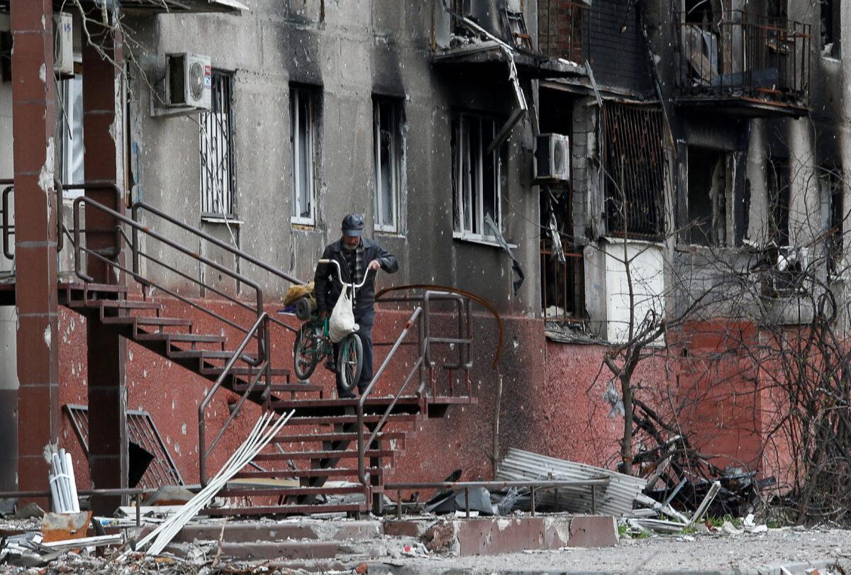 A man walks downstairs outside a residential building damaged during the Ukraine-Russia conflict in Mariupol, Ukraine, on April 21, 2022. (Alexander Ermochenko/Reuters)